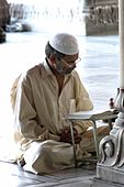 I-4. An Indian Muslim male reads the Qu'ran in a mosque
