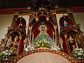 Image of Our Lady of Salambáo in the altar of Obando Church, flanked by St Paschal to her right and St Clare to her left.