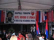 Group of people, flags and a cameraman