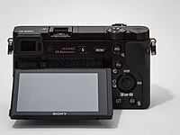 Sony Alpha ILCE-6000 APS-C-frame camera, rear view, screen tilted