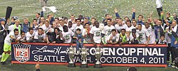 Sounders FC players with the 2009, 2010, and 2011 U.S. Open Cup trophies