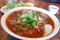 This version of bún bò Huế includes rice vermicelli, beef brisket, pork leg, pig blood curd, and other ingredients.