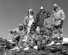 Image of seven mountain climbers wearing winter gear and standing together