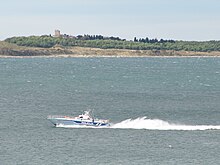 Small police boat on large body of water