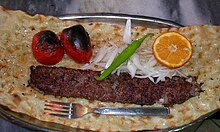 Bonab kabab with sangak bread, tomato, onion, green chili pepper, and sour orange
