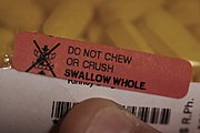 Auxiliary label with instructions to "swallow whole"