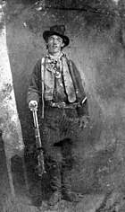 young man with rifle in Old Western garb