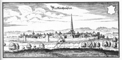 Meadows surround a fortified city, protected by thick walls, artillery towers, and a wide moat. The countryside around the city was flat, giving the inhabitants of the city, and the soldiers on its walls, an advantage of height. A church spire towers over the city and dominates the landscape.