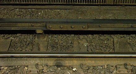 Conductor rail on the MBTA Red Line at South Station in Boston, consisting of two strips of aluminium on a steel rail to assist with heat and electrical conduction