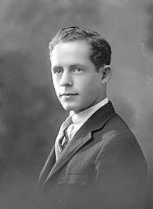 Posed photograph of a young man wearing a suit