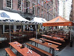 Dining tables and canopies on a portion of the Stone Street Historic District