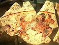 Begram vase fragments depicting a fighting scene.