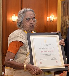 Woman holding framed certificate
