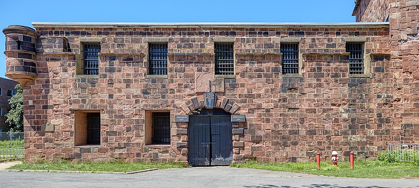 The gate of Castle Williams on Governor's Island. The plaques read "Commenced 1807" and "Completed 1811". That refers to the first establishment of the castle as a defensive fort. The prison function came only in 1903.
