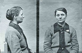 Police mugshots in black and white of middle aged woman sitting on a chair wearing a cardigan and looking listlessly into the camera
