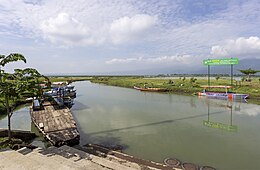 Photograph of a canal, with a dock nearby.