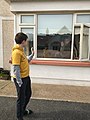 A grandson visits his grandmother who is "cocooning" in her home.