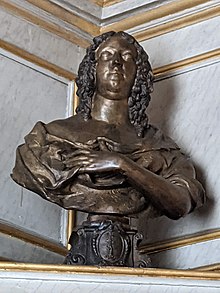 A bronze bust of a woman, shown with elaborate ringlets falling down to her shoulders, which are slightly exposed by a drooping chemise.