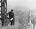 Image 14A workman helps raise the Empire State Building 25 floors higher than the Chrysler Building (at right), as seen in 1931. (from History of New York City (1898–1945))