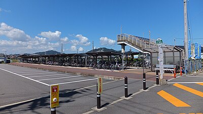 A view of the station forecourt, showing the bike sheds. The station building is outside the frame, to the right.