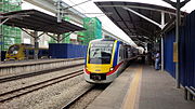 KTM Komuter train at the KTM station, with the MRT station construction in progress in the background.