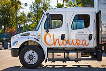 Semi truck featuring the Choura Events' logo prominently displayed on the driver's side door.
