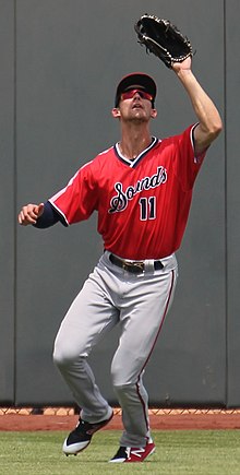 A baseball player in red and gray