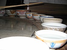 row of bowls, mostly filled with water