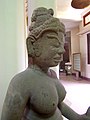 A 9th-century sandstone statue shows Tara with a small figure of Amitabha seated in her hair above the forehead.
