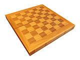 A folding wooden chessboard