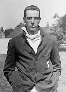 A black and white photograph showing a bare-headed cricketer wearing a Kent blazer from the waist up
