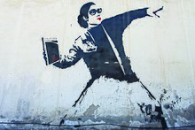 Street art with a Librarian women trowing a book like a grenade