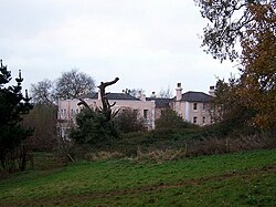 View of part of Primley House, partially obscured by trees in front