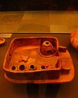 A clay model of a Cucuteni-Trypillian house, showing a pottery kiln in the upper-right, and a cross-shaped cooking hearth to the left.