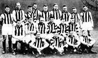 A group of men wearing sleeveless guernseys with black-and-white vertical stripes