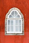 Wooden window set against a red wall at Palácio Nacional da Pena