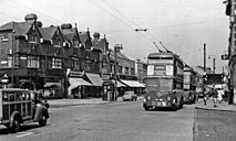 Photograph of a street with trolleybuses and a police box on the pavement