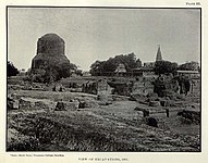 View of Sarnath during archaeological excavations, 1907. Camera angle from the ruins of the ancient Mulagandha Kuty Vihara towards the Dhamek Stupa; the Sri Digamber Jain temple can be seen on the right side of the photograph.