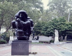 A color photograph showing a sculpture on a brick terrace