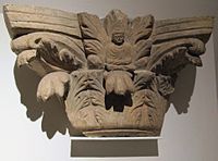 Indo-Corinthian capital, with figure of the Buddha inside acanthus leaves. Tapa Kalan.