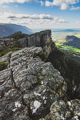 Bare rocks with a large outcrop, and flat plains in the background