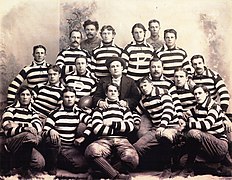 Group photo of the Pomona football team wearing thick striped shirts