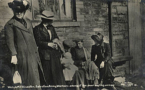 A female Salvation Army officer comforts a family