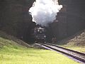 A train with Terrier 672 Fenchurch leading exits the tunnel