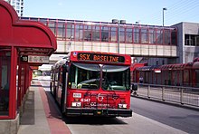 Red bus at a station