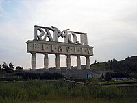 Ornate outdoor sign on pillars, reading "Ramoji Film City"