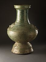 Han dynasty hu funerary jar, wheel-thrown earthenware with molded and applied decoration and green glaze