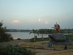 Quiet waterfront in Solapur, with a statue in the foreground