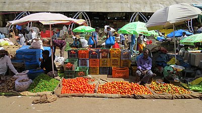 Tomato seller in the open-air section