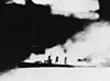 The U.S. cruiser Quincy on fire and sinking